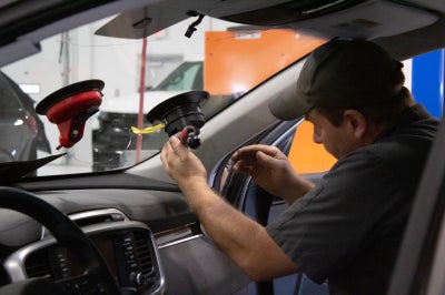 Karl Chevrolet of Stuart technician balancing a tire