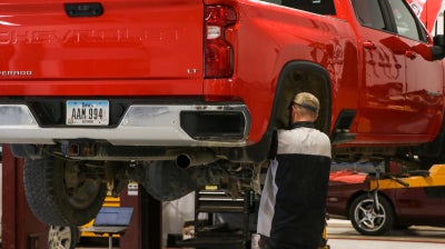 Karl Chevrolet of Stuart technician servicing a vehicle on a lift